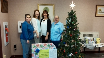 From left, assistant Hellertown borough manager Tina Krasnansky, administrative assistants Angie Bauer and Tanya Stametz, and police department secretary Pat Tallarico stand next to the bin where items are being collected for the Lehigh Valley Outreach Depot at Hellertown Borough Hall.