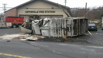 A garbage truck struck a utility pole and rolled over in front of the Leithsville fire station in Lower Saucon Township Tuesday morning, closing a busy section of Rt. 412.