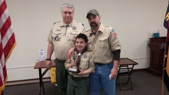 Cub Scout Joey DiRusso, 11, of Lower Saucon Township, was recently honored for selling more than $12,000 in microwaveable popcorn as part of a pack fundraiser. He is pictured with Scoutmaster Richard Hawk, left, and his father, Joe DiRusso.