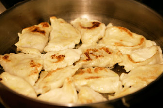 Pierogies being fried in a pan (FILE PHOTO)