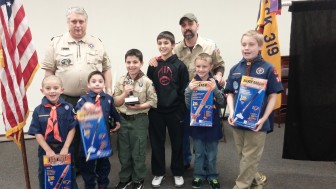 Cub Scout Pack 319's top popcorn sellers pose for a photo with prizes they received for their fundraising Dec. 19.