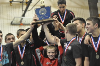 Saucon wrestlers celebrate with the 2014-2015 Colonial League Wrestling Championship trophy.