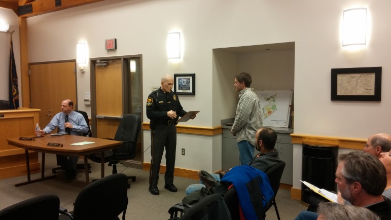 Lower Saucon Township Police Chief Guy Lesser presents a DUI enforcement commendation to Officer Willie Shelly.