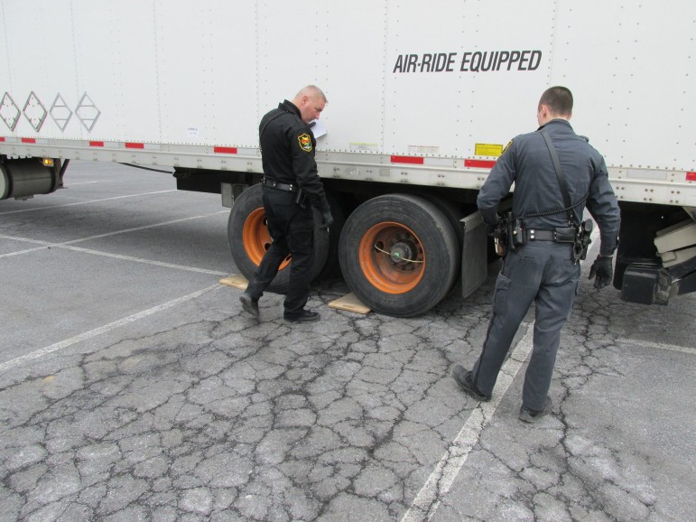 Lower Saucon Township Police officers Charles Werkheiser and John Bowlby conduct an inspection/weighing of a truck at Se-Wy-Co Fire Co. on Wednesday, March 25, 2015.