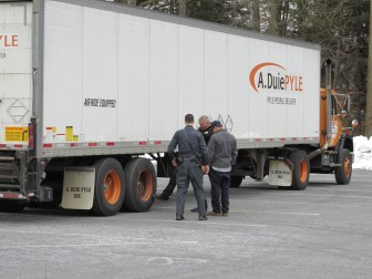 Lower Saucon Township Police officers Charles Werkheiser and John Bowlby inspect a tractor-trailer on Wednesday, March 25, 2015.