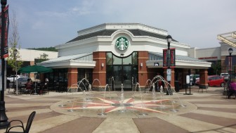 The pop-jet fountain in front of Starbucks in the Promenade Shops at Saucon Valley's Town Square is a popular play area for small children during the summer.