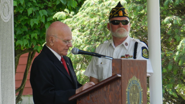Hellertown Mayor Richard Fluck speaks at the Memorial Day ceremony as Legion Post 397 Commander Geoff Baer looks on.