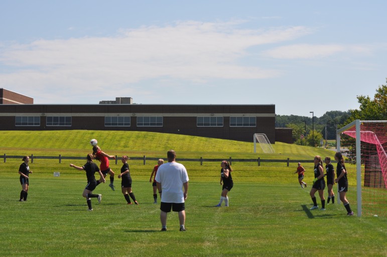 Saucon senior Paige Jones attempts a header off Lauren Binn's corner kick.