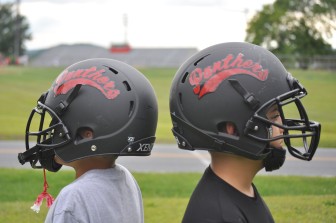 Two Saucon Valley Youth football players model their new helmets.