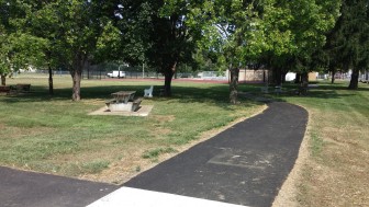 A newly-paved path connects the driveway entrance to Water Street Park with a new basketball court.