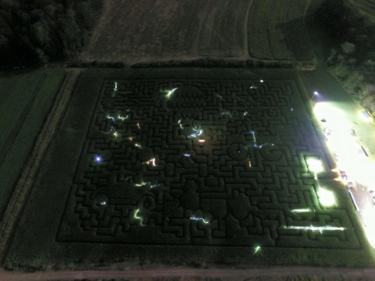 An aerial view of the Mazezilla corn maze at night, when many visitors use flashlights.