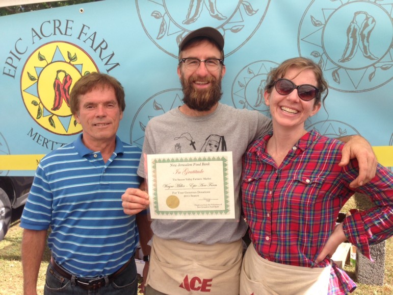 Manny from New Jerusalem Food Bank in Lower Saucon Township presents a certificate of appreciation to Wayne Miller of Epic Acre Farm at the Saucon Valley Farmers' Market.