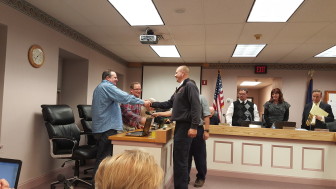 Newly-elected Dewey Fire Co. Chief Mike Maguire is congratulated by Hellertown borough councilman Mike McKenna on Monday, Nov. 2, 2015.