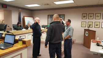 Hellertown Mayor Richard Fluck administers an oath of office to new Dewey Fire Co. Chief Mike Maguire as newly-appointed assistant fire chief Jon Lau looks on.