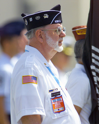 A Korean War Veteran, Ed "Doc" Brown stands at attention during a repatriation ceremony held July 10, 2001 at Hickam AFB, Hawaii. Dozens of Veterans were in attendance to honor the 17 unaccounted for US serviceman from North Korea, Vietnam and Laos.