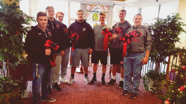 Saucon Valley football players Nate Harka, Trey Polak, Christian Carvis, Cody Zrinski, Ryan Meyers, Mike Kane and Steven Good hold the bows that are being sold as a fundraiser for Hellertown Historical Society and Saucon Valley Athletic Association, and to help raise community spirit before Saturday's PIAA AAA semifinal football game in which the Saucon Valley Panthers will play Imhotep Charter.