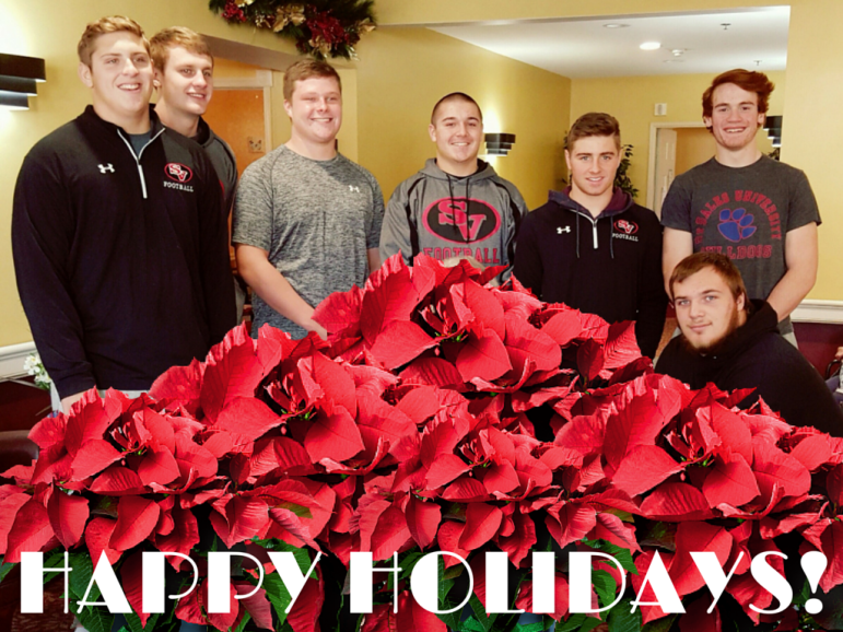 Saucon football players Trey Polak, Mike Kane, Ryan Meyers, Steven Good, Nate Harka, Christian Carvis and Cody Zrinski delivered poinsettias to Saucon Valley Manor residents in Hellertown Sunday.