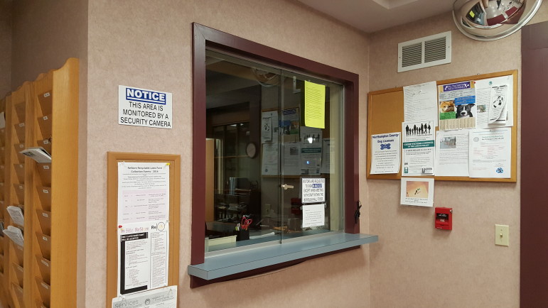 The current transaction window near the entrance to Hellertown Borough Hall features standard sliding glass windows.