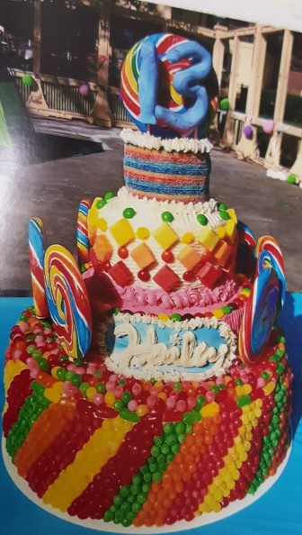 Custom cakes and cake pops are one of Hellertown Bakery owner Leiane McCarty's specialties. Pictured is a custom candy-covered cake she baked for a 13th birthday party. The bakery will have a photo-book of McCarty's cake creations on hand for customers to peruse.