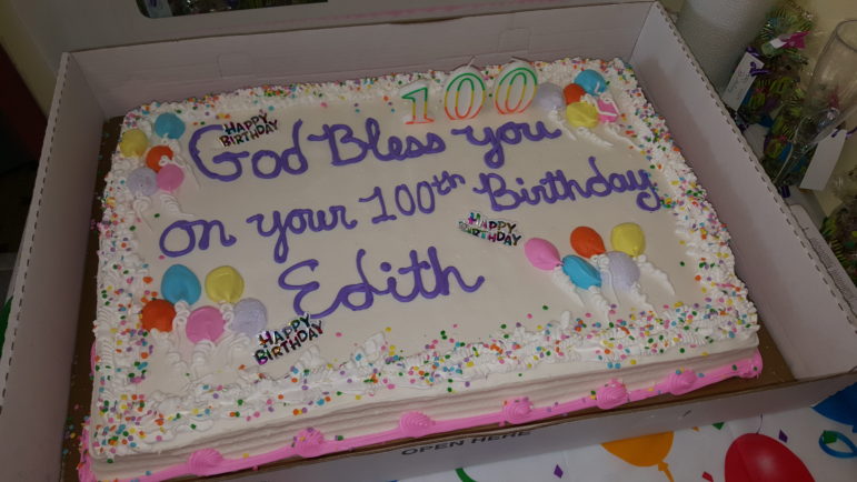 A full-size sheet cake was presented to Edith Muldowney, who blew out the candles on it herself.