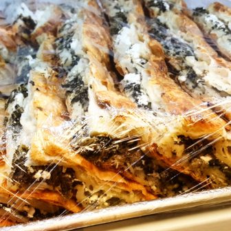 Spinach pie is prepared with feta cheese and flaky phyllo dough.