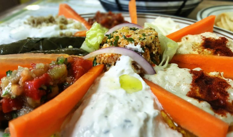 A small appetizer plate at Limon features traditional Turkish/Middle Eastern dips such as hummus and baba ghanoush, as well as tabbouleh, stuffed grape leaves and tzatziki sauce, all drizzled with a touch of lemon-infused olive oil.
