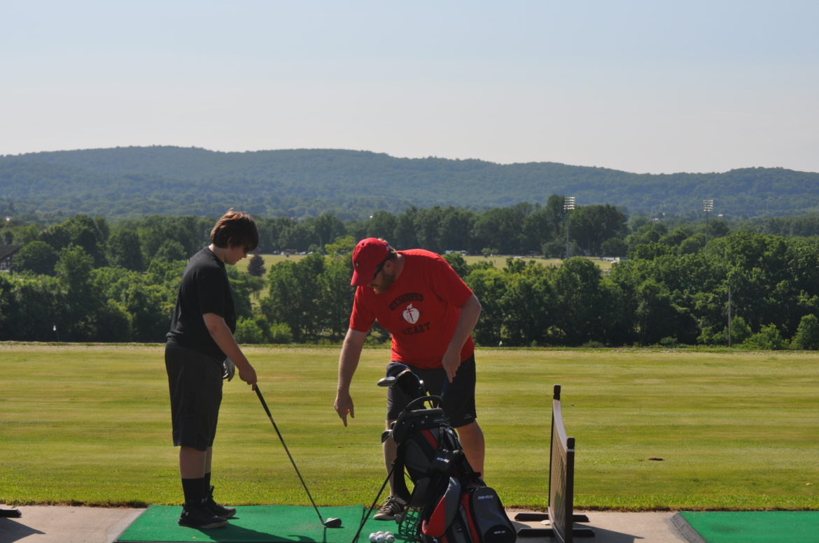 Saucon Golf coach Scott Roberts instructs sophomore Riley Martin.