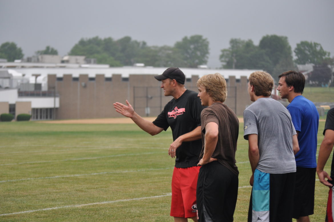 New Saucon valley football coach Phil Sams explaining another drill.