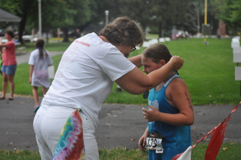 Hailey Carroll crosses the finish line and completes the triathlon.