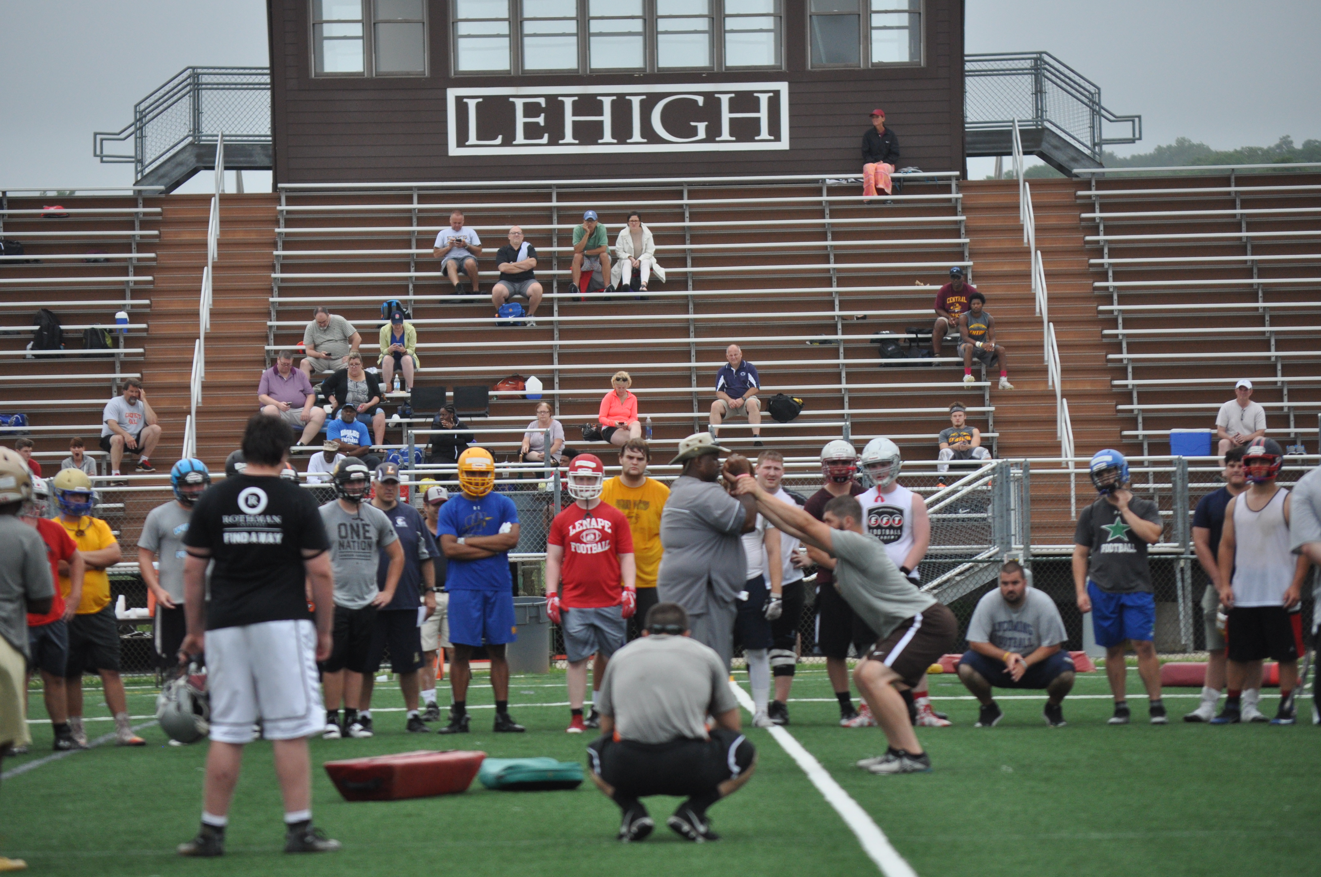 Lehigh defensive line coach Donnie Roberts demonstrates a drill for the high school players.