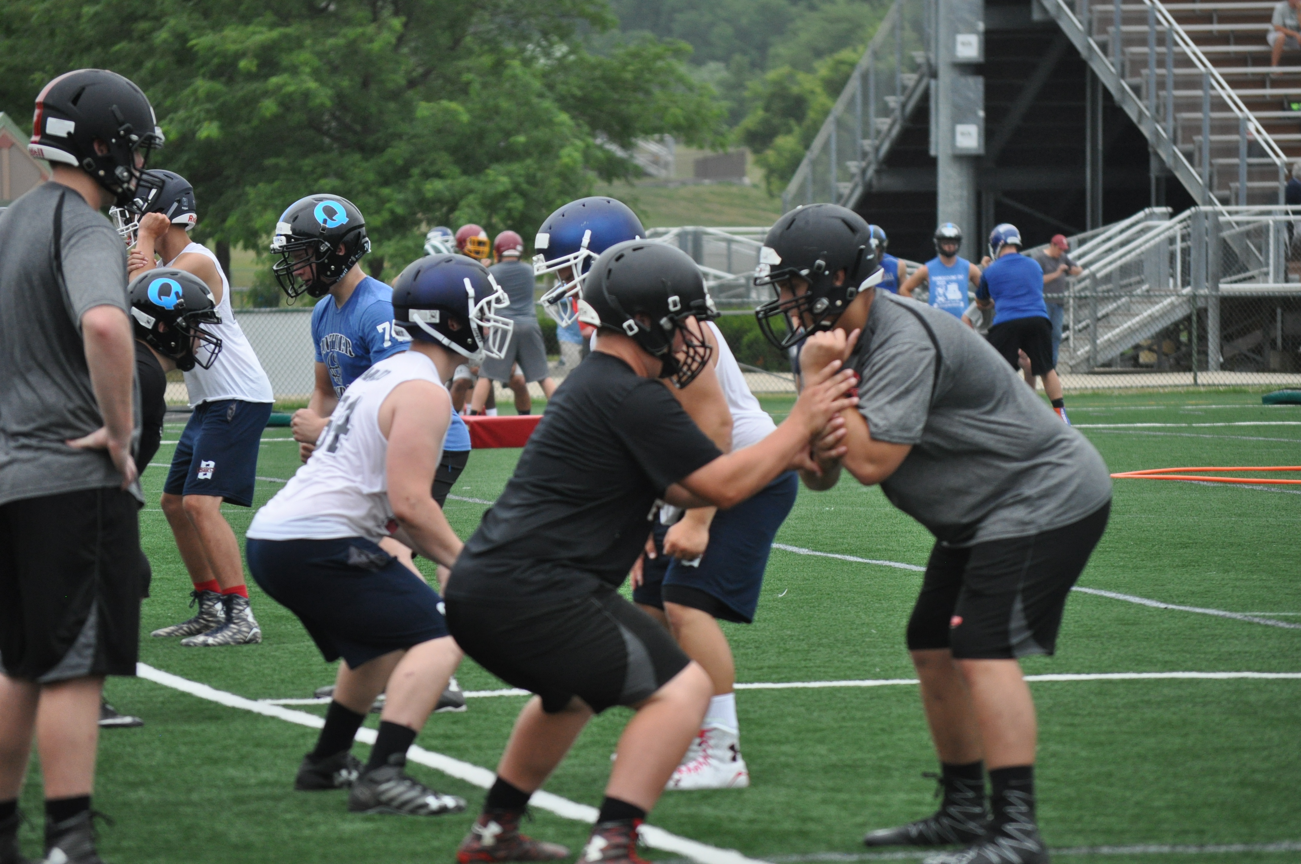 Saucon Valley's Ryan Meyers and Trey Polak working on a hand placement drill as Tim Weaver looks on.