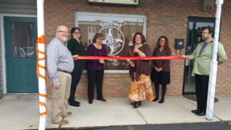 Kindred Spirits Books & Gifts owner June Rose (center) prepares to cut the ribbon on an extension of her business--Sacred Space--in Hellertown Saturday. Looking on are Hellertown-Lower Saucon Chamber's Mark Albright, and the Sacred Sisters: 