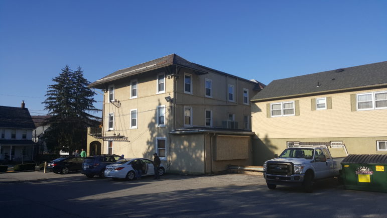 A side view of Hellertown Crossroads Hotel, viewed from its parking lot