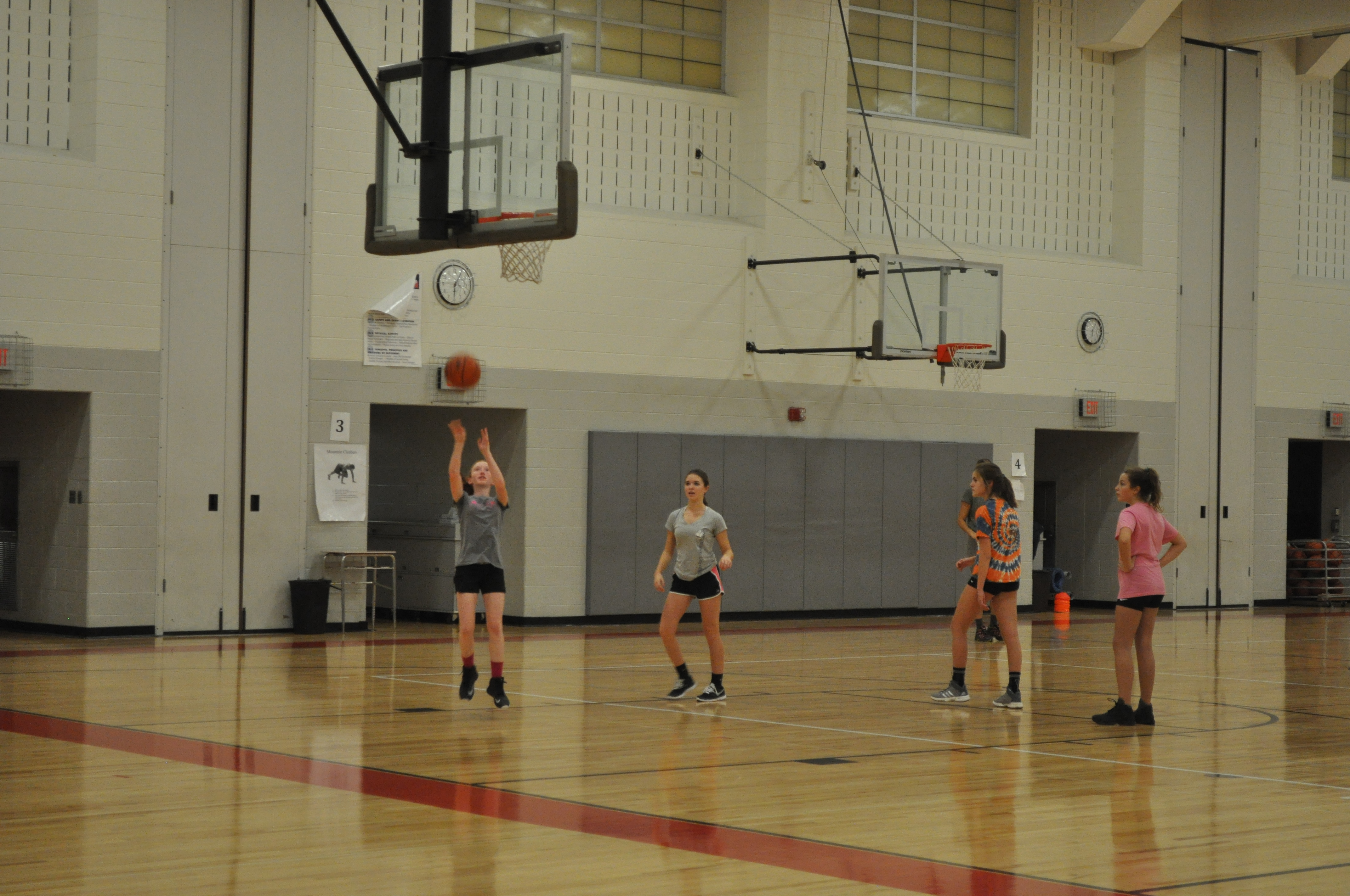 Coaches Roger Ochse and Scott Guidos working layups with the middle school girls.