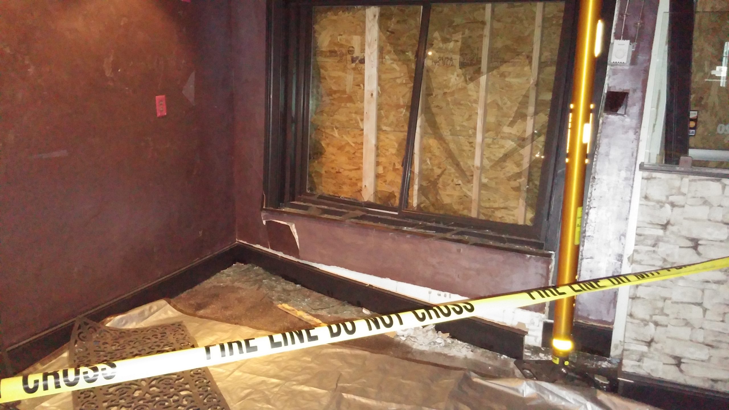Yellow caution tape is strung across the damaged front corner of the Sagra Bistro building Sunday evening.