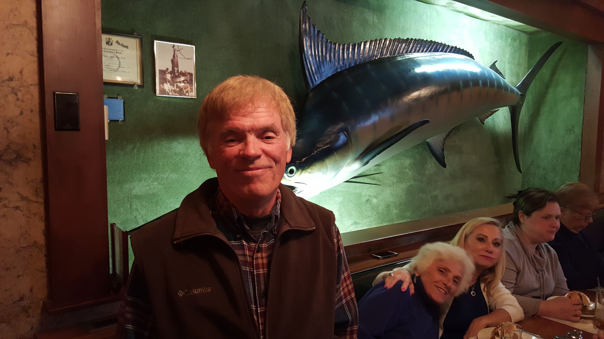 Manny Aguiar of Hellertown stands next to the giant blue marlin inside Matey's Crossroads Hotel in Hellertown. Aguiar was part of the fishing expedition that netted the record-setter in September 1980.