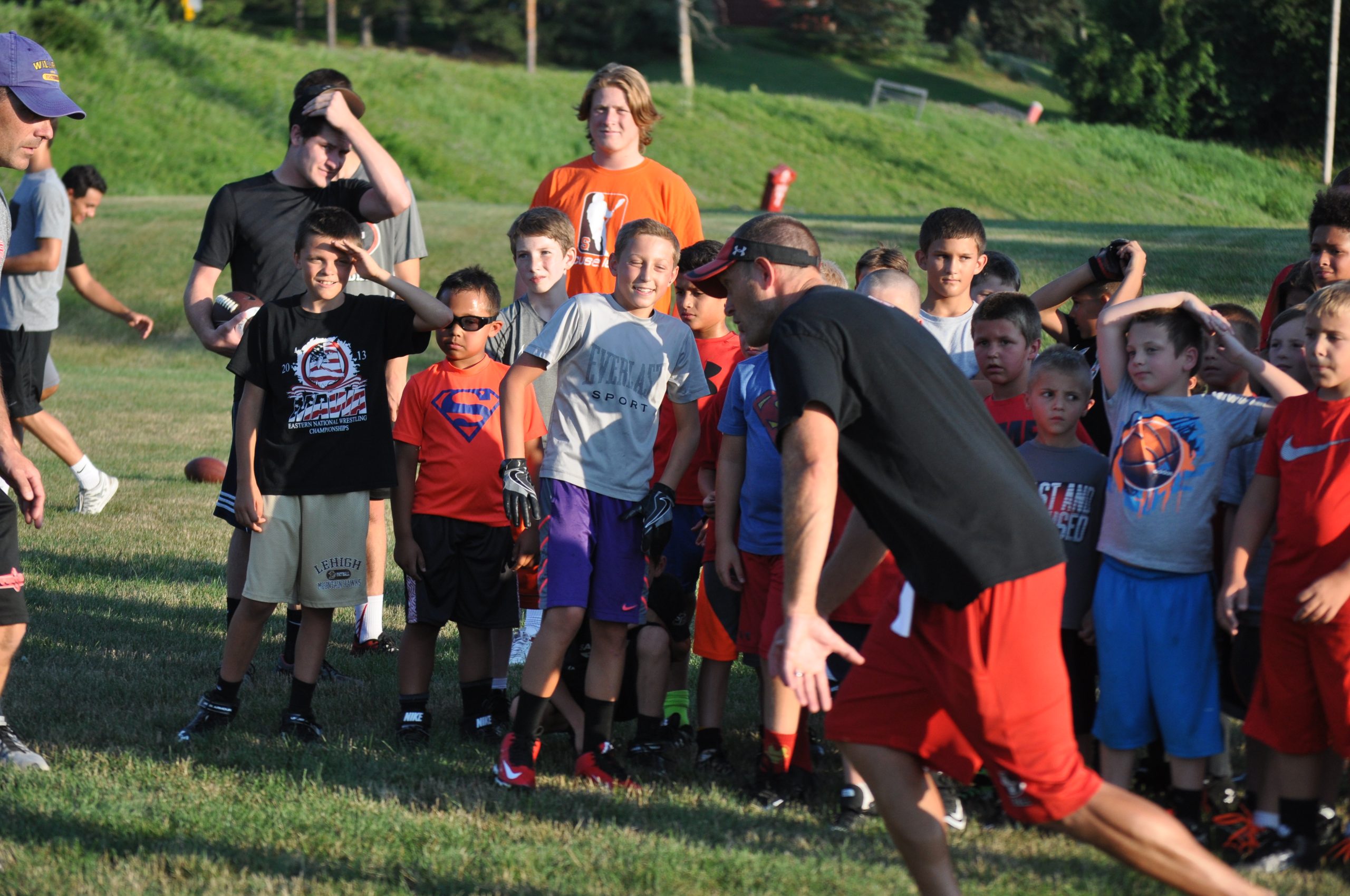 Panthers Head Coach Phil Sams demonstrating a wide receiver technique for his campers.