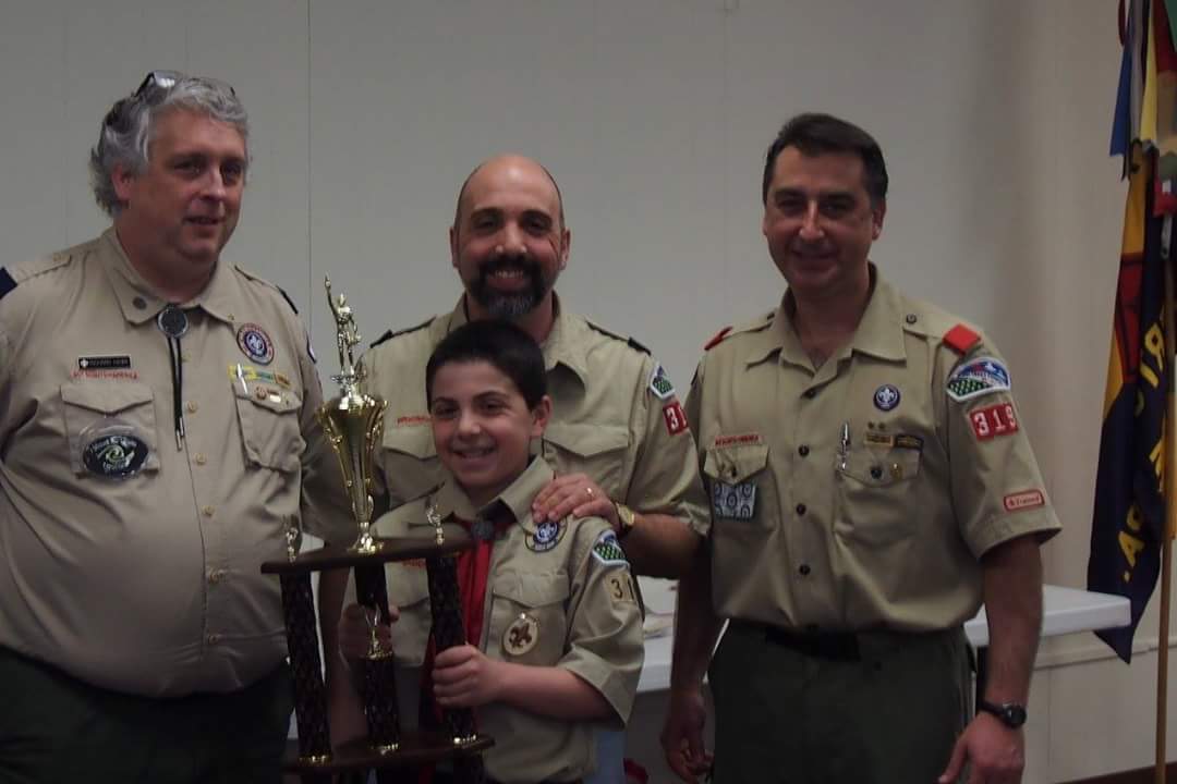 Boy Scout Troop 319 member Joey DiRusso is congratulated by troop leaders Rich Hawk, his father Joe DiRusso and Tony Schriffert for selling more than $17,000 in the troop's annual popcorn fundraiser.