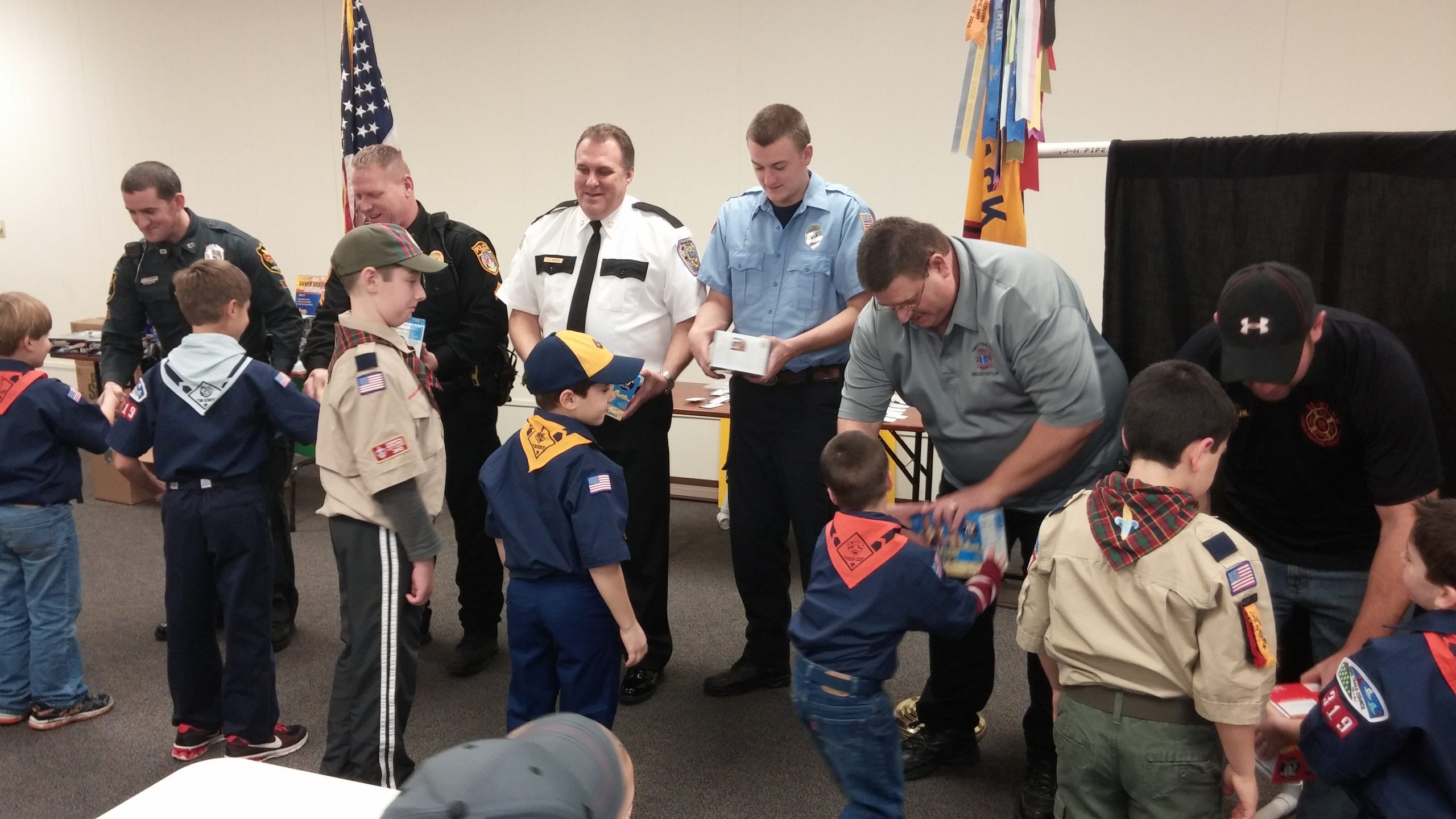 Cub Scouts present popcorn to local first responders, who were invited to attend their end-of-the-year awards ceremony and pizza party at New Jerusalem Evangelical Lutheran Church in Lower Saucon Township Dec. 19.