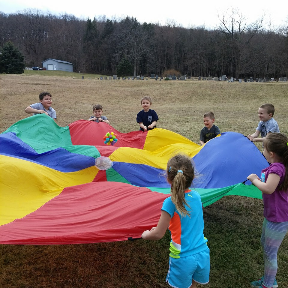 Parachute play is an activity at Apple's Preschool in Lower Saucon Township.