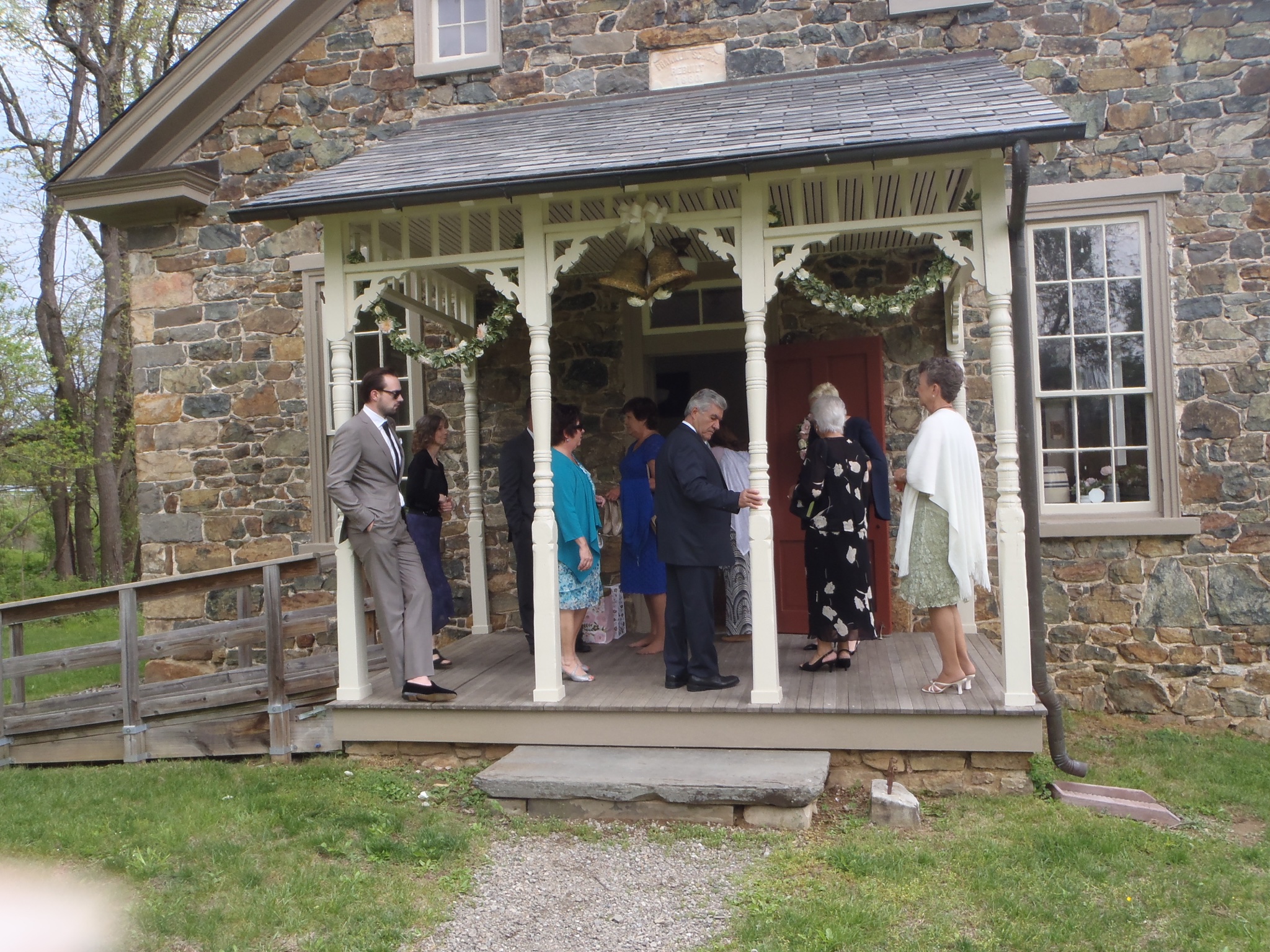 Guests at the wedding gather on the porch of the one-room school.