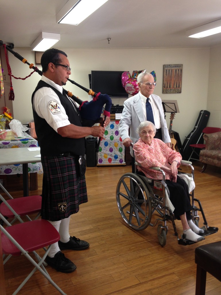 Lower Saucon Township resident Minnie Poulton is serenaded by a bagpiper at her 108th birthday party.