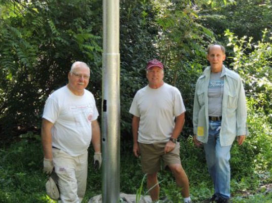 Volunteers from the Saucon Rail Trail Oversight Commission take a break from their work for a photo.