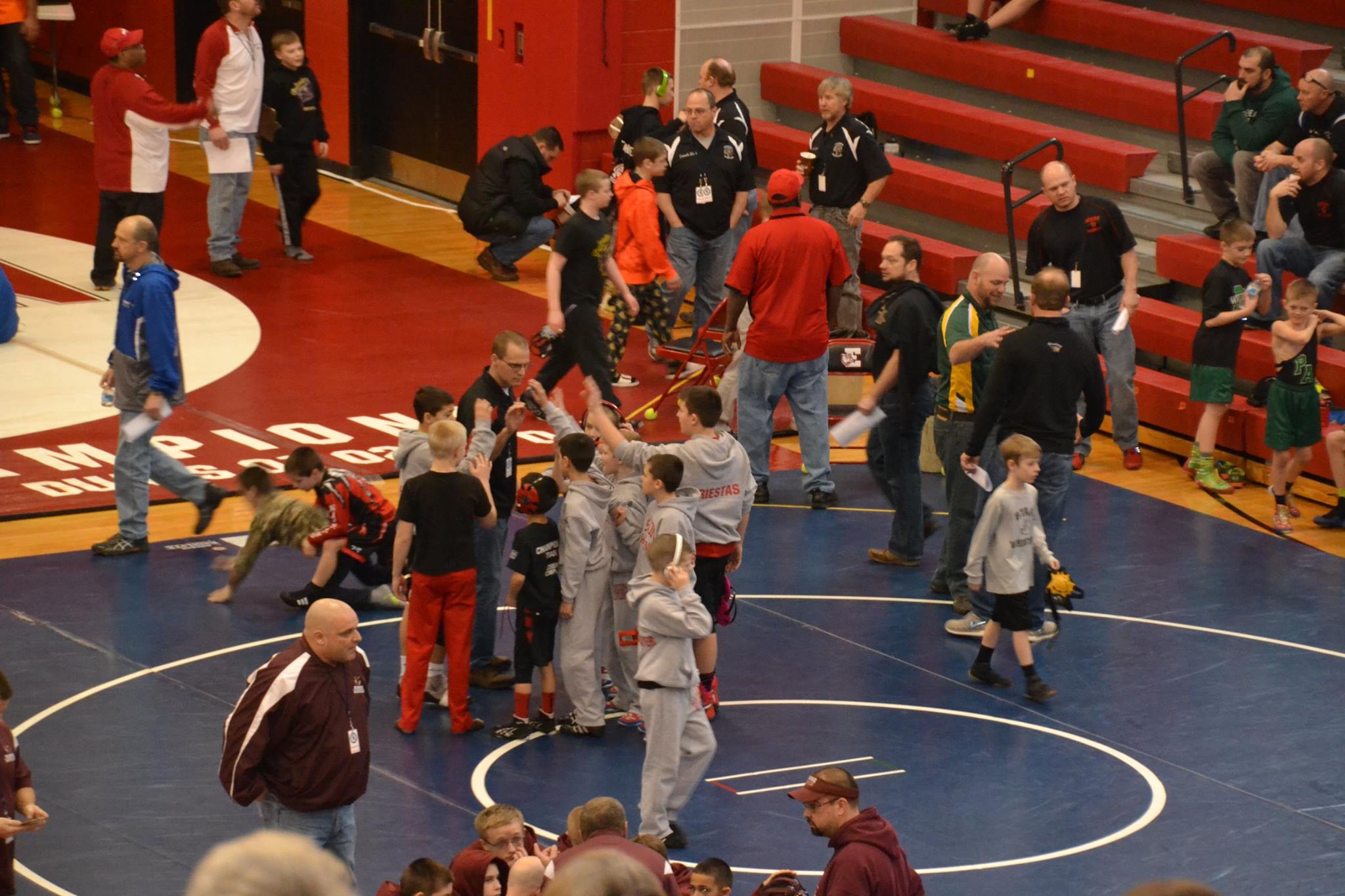 Saucon youth wrestlers gather around Coach Csencsits for a pre-tourney pep talk.