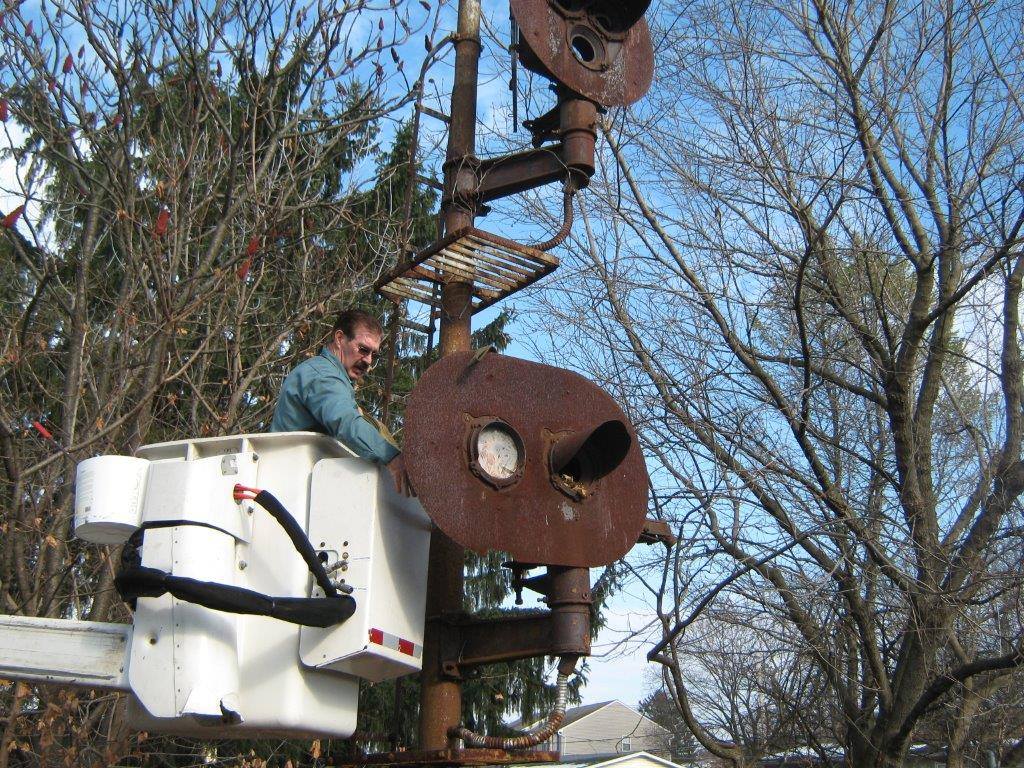 Hellertown Public Works Director Tom Henshaw works to dismantle the historic railroad signal along the Saucon Rail Trail.
