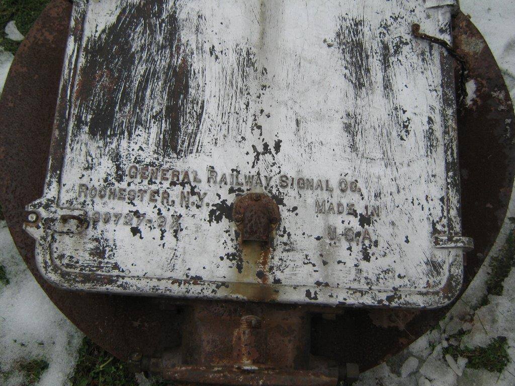 A portion of the historic railroad signal indicates that it was manufactured by the General Railway Signal Co. in Rochester, N.Y.