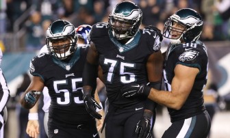 Oct 12, 2014; Philadelphia, PA, USA; Philadelphia Eagles linebacker Brandon Graham (55) and defensive end Vinny Curry (75) and linebacker Connor Barwin (98) celebrate a defensive stand during the first half at Lincoln Financial Field. The Eagles defeated the Giants 27-0. Mandatory Credit: Bill Streicher-USA TODAY Sports